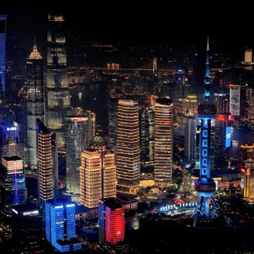 Shanghai city at night with glowing signs and modern buildings